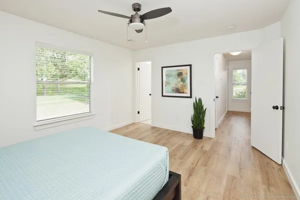 a bedroom with a bed and a potted plant