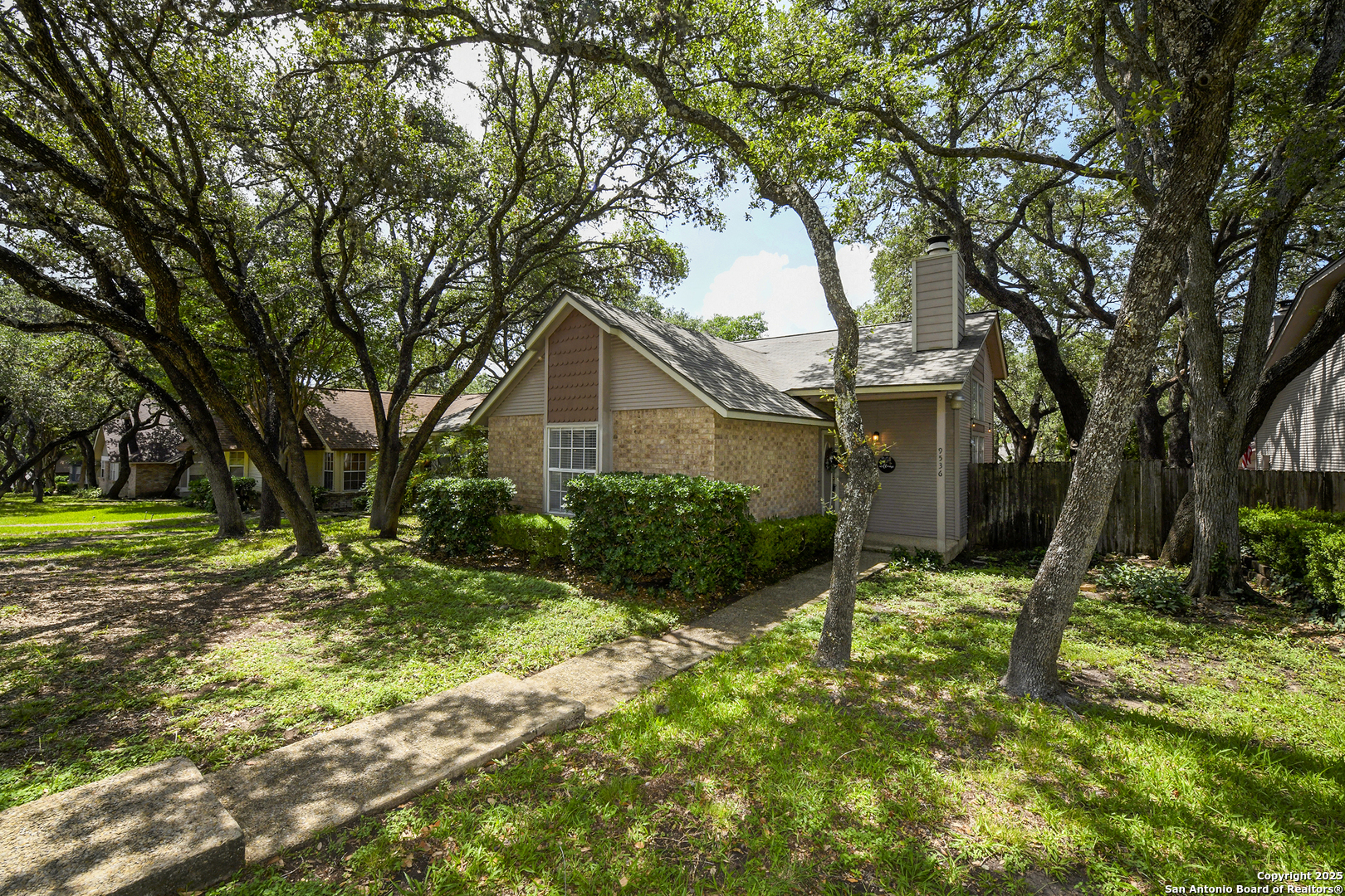 9536 Dover Ridge San Antonio, TX 78250 - Photo 2 of 9 a backyard of a house with lots of green space