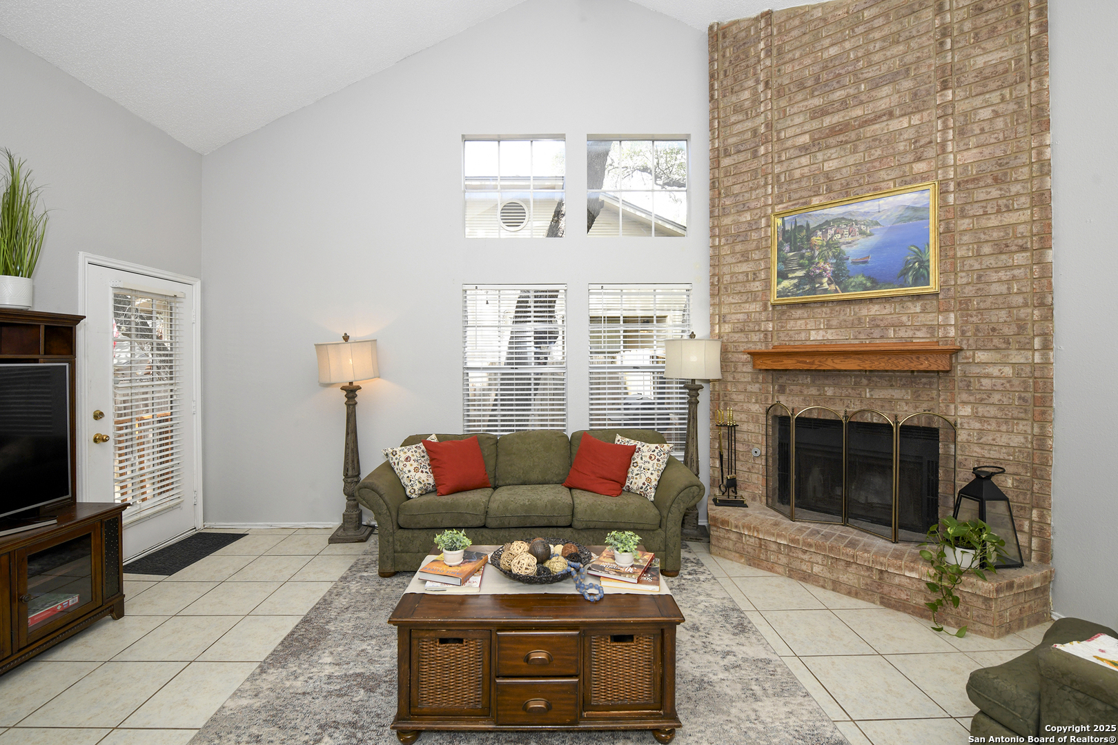 9536 Dover Ridge San Antonio, TX 78250 - Photo 3 of 9 a living room with furniture a flat screen tv and a fireplace