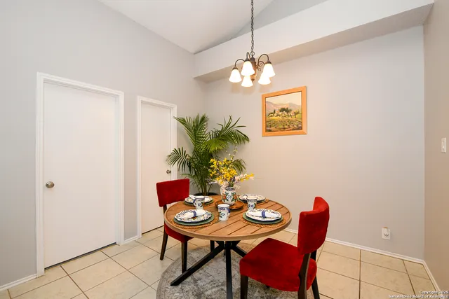 a view of a dining room with furniture and chandelier