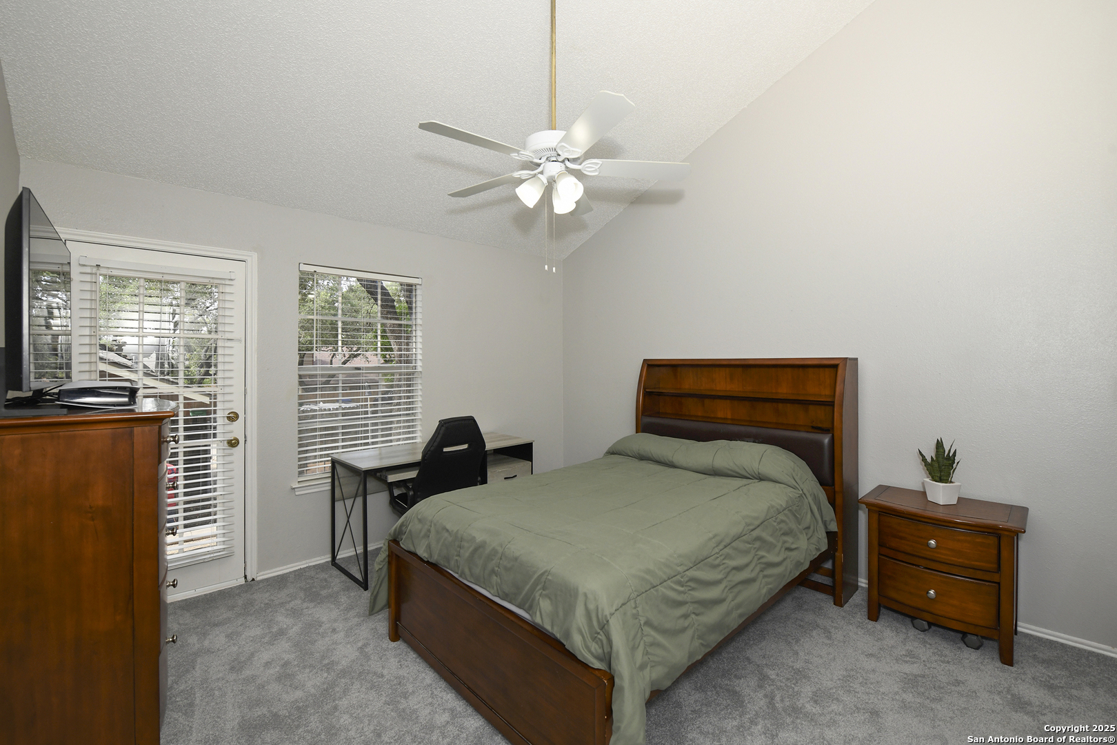 9536 Dover Ridge San Antonio, TX 78250 - Photo 6 of 9 a bedroom with a bed and a chandelier