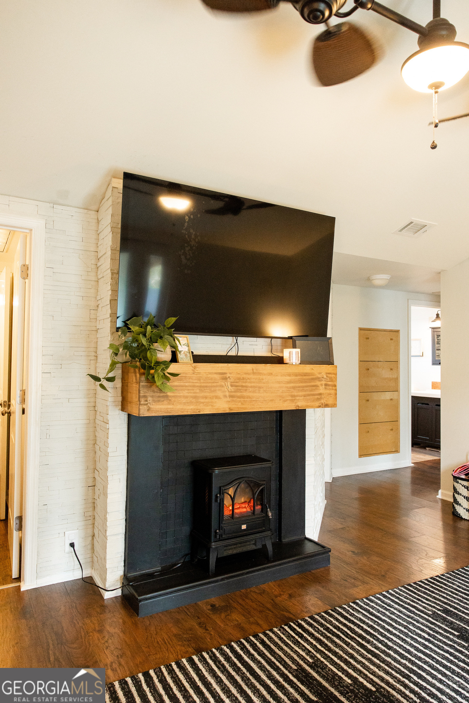 5720 N Highway Springfield, GA 31329 - Photo 12 of 27 a living room with furniture a fireplace and a flat screen tv