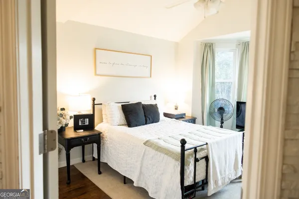 a bedroom with a bed and a mirror