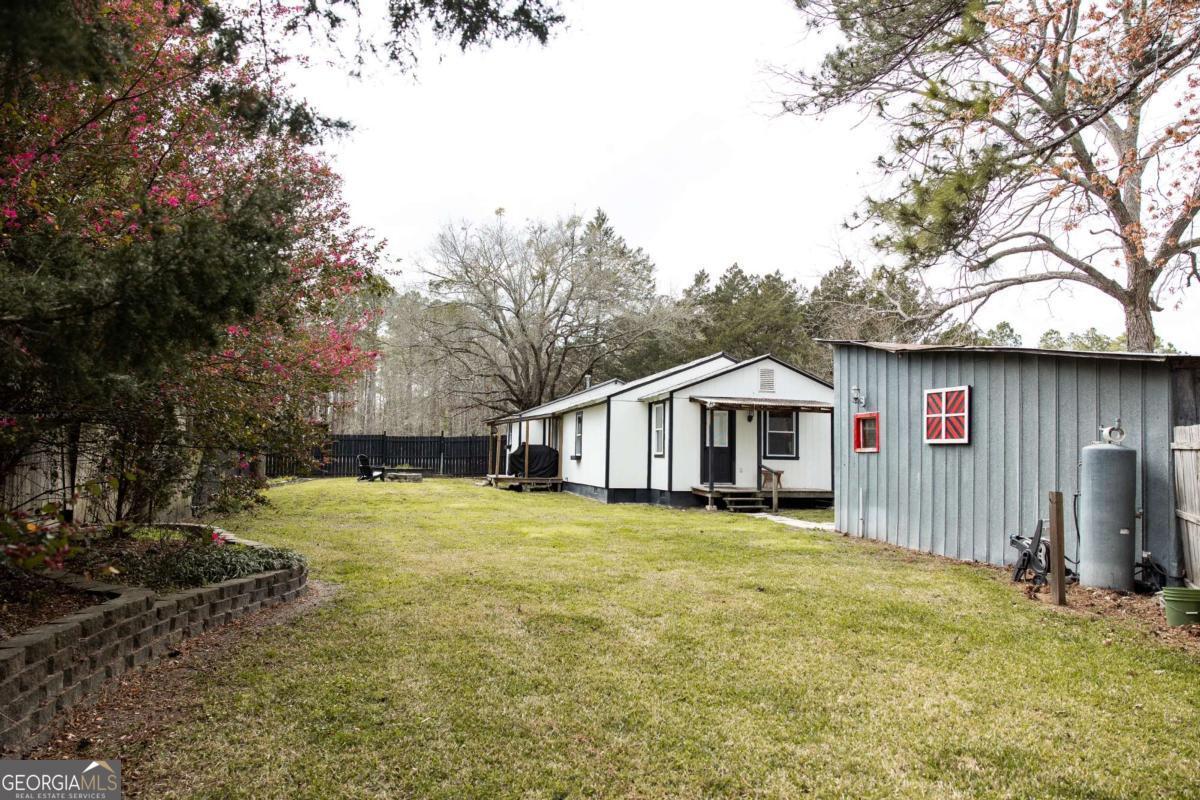 5720 N Highway Springfield, GA 31329 - Photo 22 of 27 a view of a house with a yard covered in snow