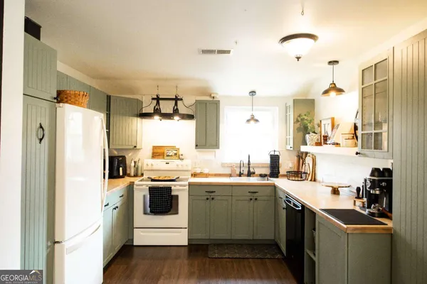a kitchen with a sink stove and refrigerator