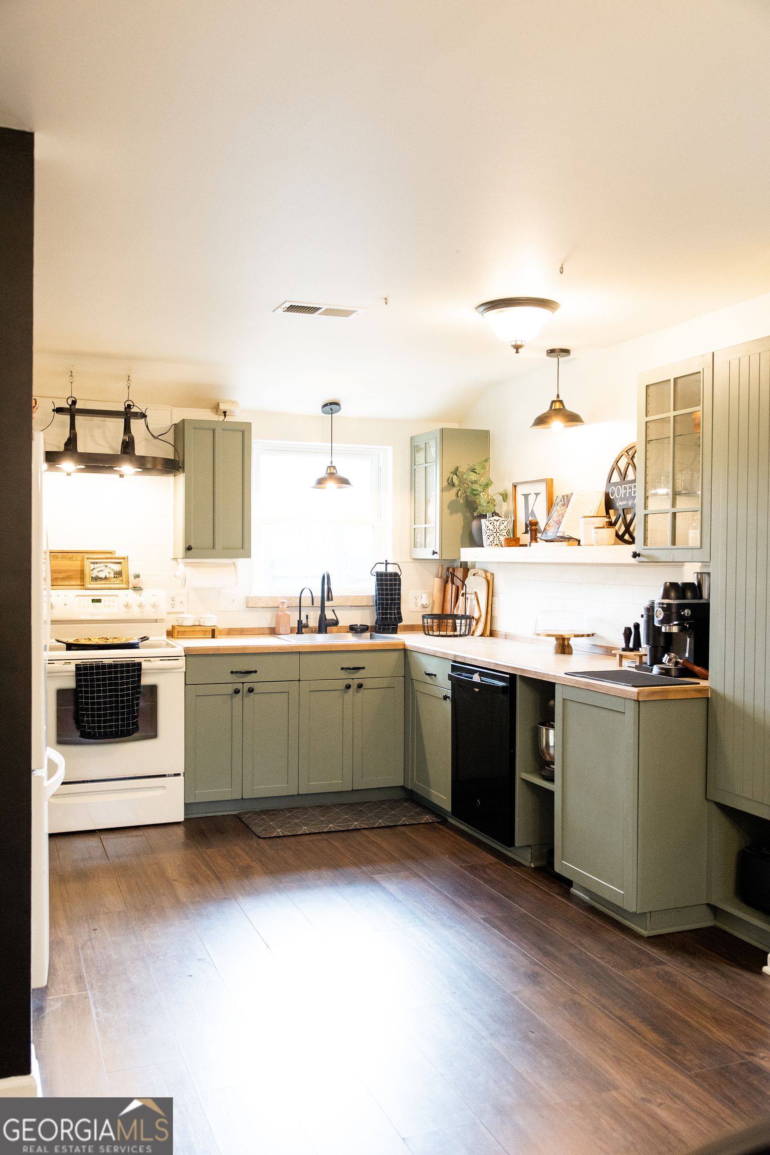 5720 N Highway Springfield, GA 31329 - Photo 7 of 27 a kitchen with stainless steel appliances kitchen island granite countertop a sink and cabinets