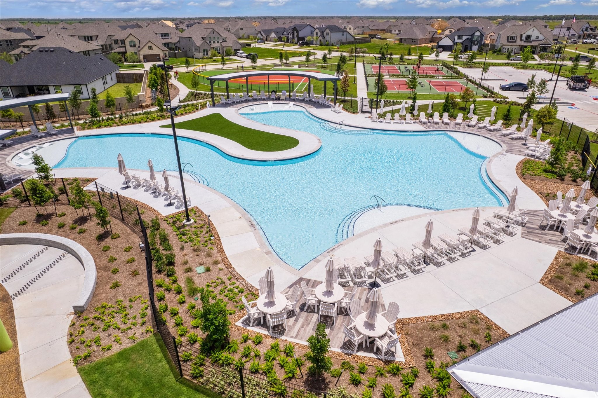 3214 Rios Court League City, TX 77573 - Photo 28 of 35 Your private paradise awaits! Explore our incredible resort-style community pool, complete with ample seating, lush landscaping, and sparkling blue water for endless relaxation and fun.