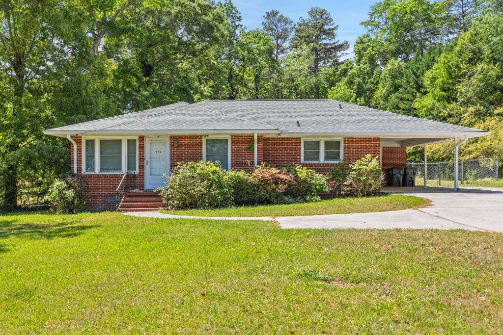 a view of house with a yard