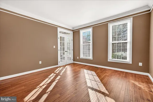 a view of room with window and wooden floor