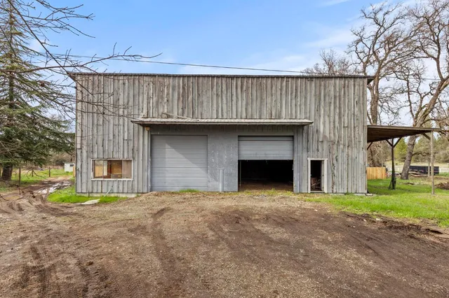 a view of a house with a yard and sitting area