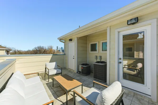 a balcony with table and chairs