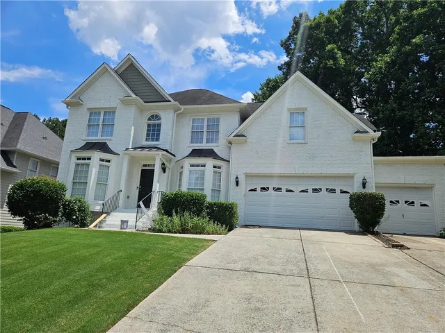 a front view of house with yard and green space