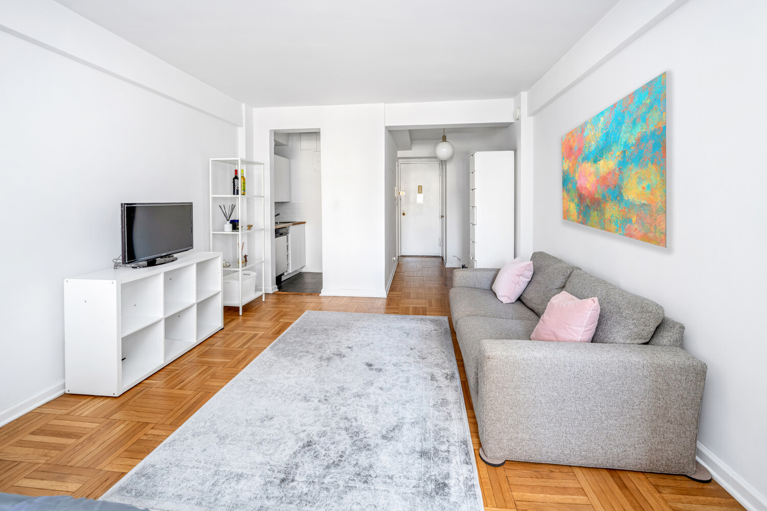 288 Lexington Avenue, Unit 12C Manhattan, NY 10016 - Photo 2 of 6 a bedroom with a bed and a flat screen television