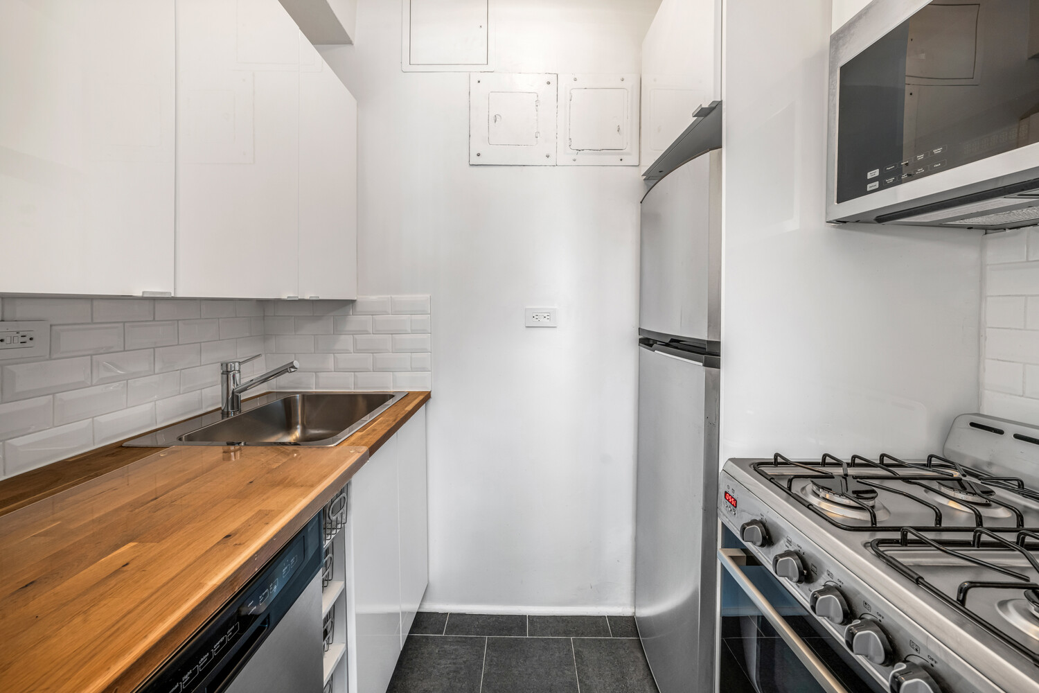 288 Lexington Avenue, Unit 12C Manhattan, NY 10016 - Photo 3 of 6 a kitchen with stainless steel appliances granite countertop a sink stove and refrigerator