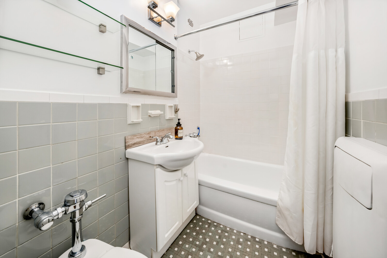 288 Lexington Avenue, Unit 12C Manhattan, NY 10016 - Photo 4 of 6 a bathroom with a sink a toilet and shower