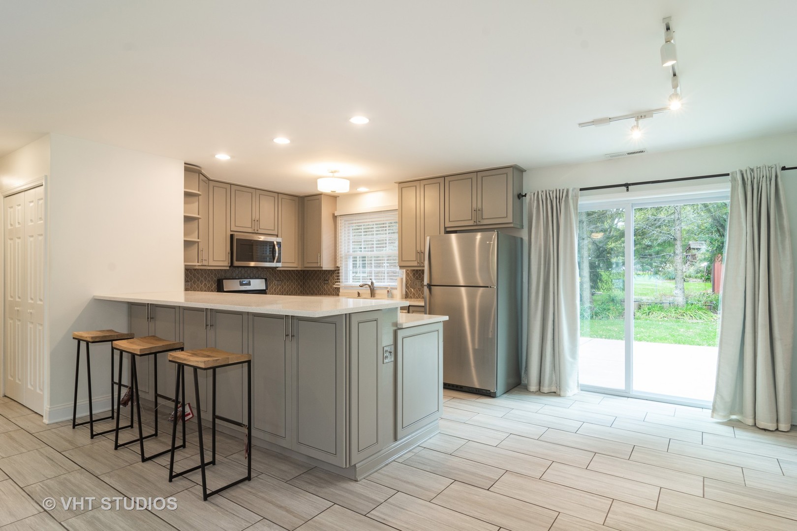 422 Glen Garry Road Cary, IL 60013 - Photo 3 of 12 a kitchen with stainless steel appliances granite countertop a refrigerator and a stove top oven