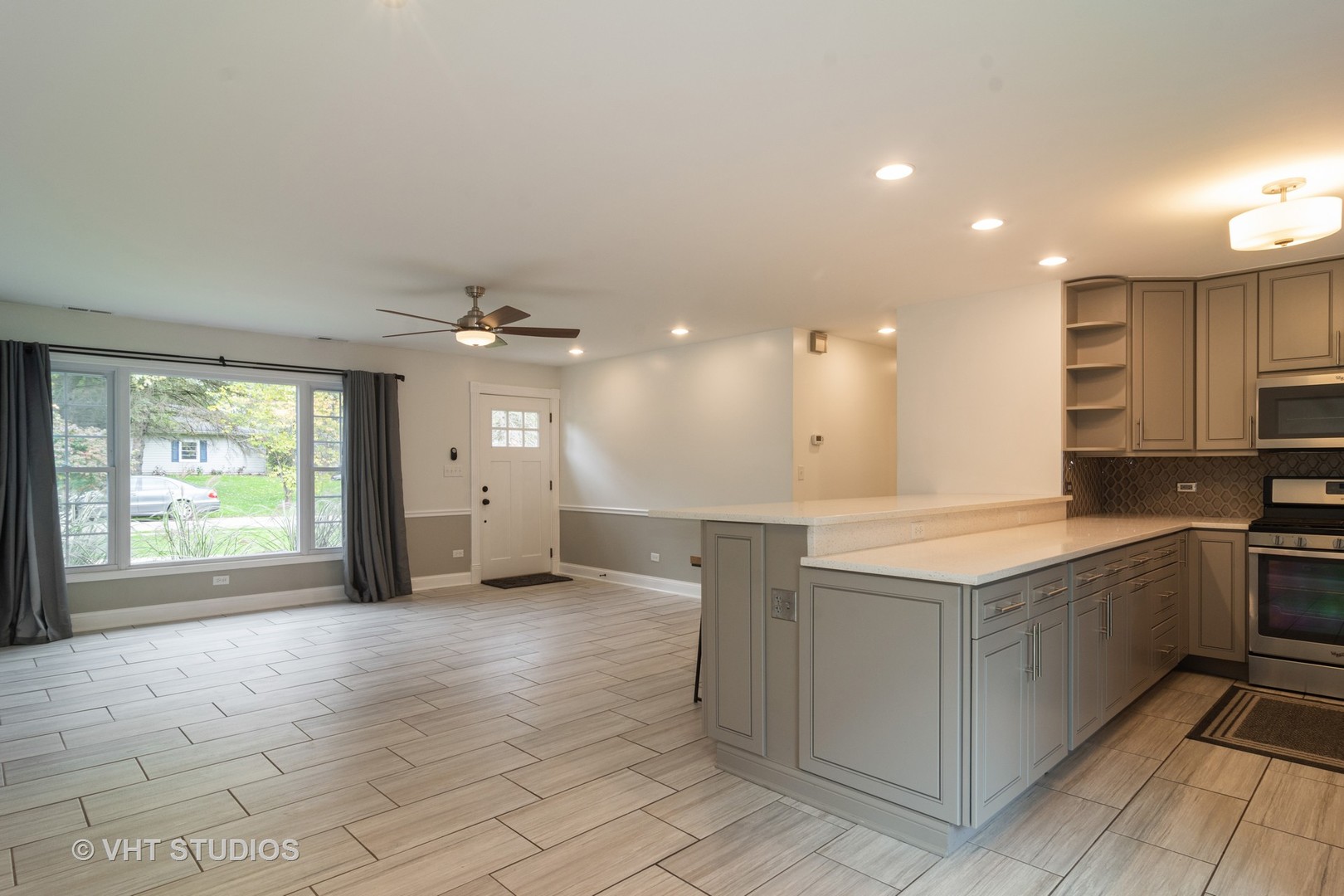 422 Glen Garry Road Cary, IL 60013 - Photo 6 of 12 a large kitchen with kitchen island granite countertop a sink and a stove