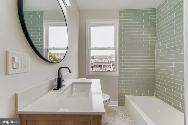 a bathroom with a sink a toilet and a bathtub