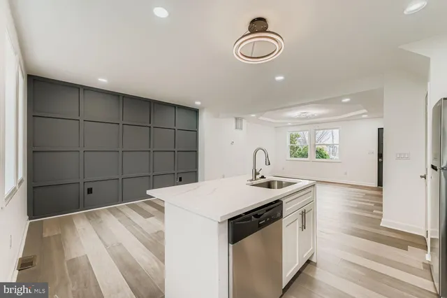 a kitchen that has a sink and a stove