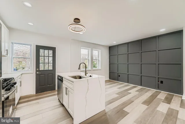 a kitchen with a sink and a stove top oven