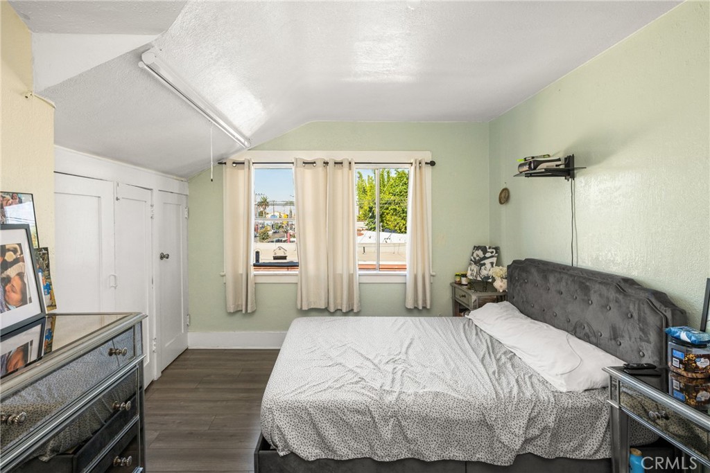 1912 East 10th Street Long Beach, CA 90813 - Photo 12 of 15 a bedroom with a bed and wooden floor
