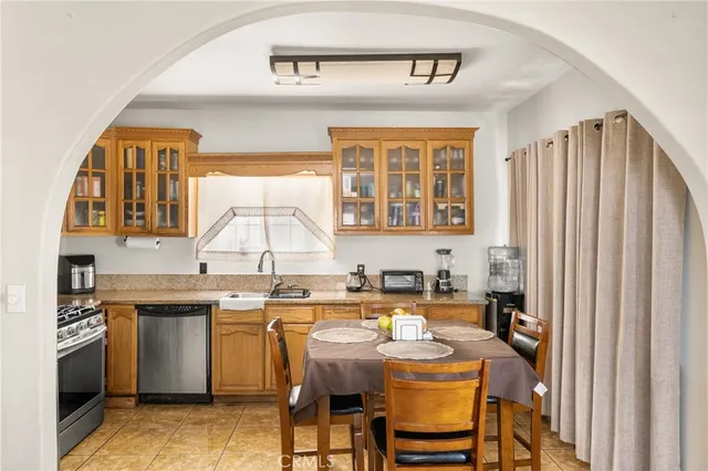 a kitchen with a sink a stove and chairs