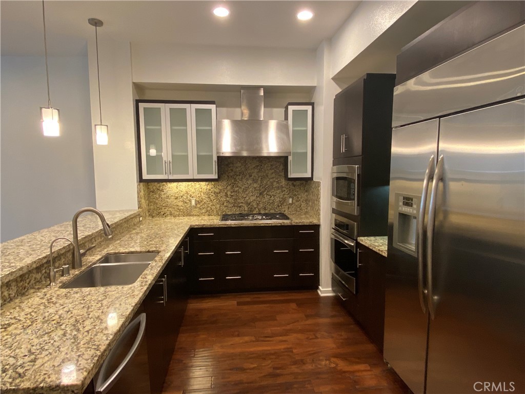 21 Gramercy, Unit 116 Irvine, CA 92612 - Photo 3 of 9 a kitchen with a refrigerator sink and stove
