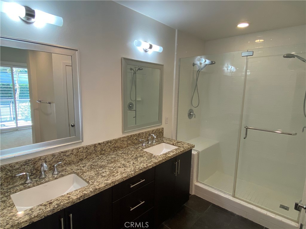 21 Gramercy, Unit 116 Irvine, CA 92612 - Photo 6 of 9 a bathroom with a granite countertop sink and a mirror