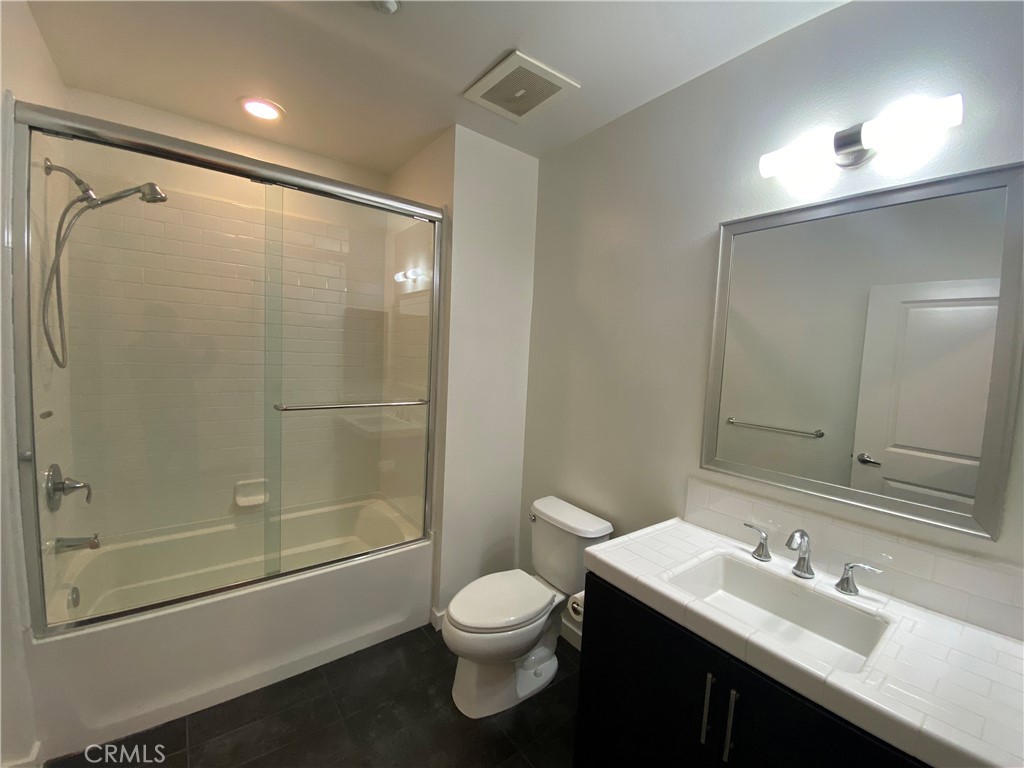21 Gramercy, Unit 116 Irvine, CA 92612 - Photo 8 of 9 a bathroom with a sink toilet and shower