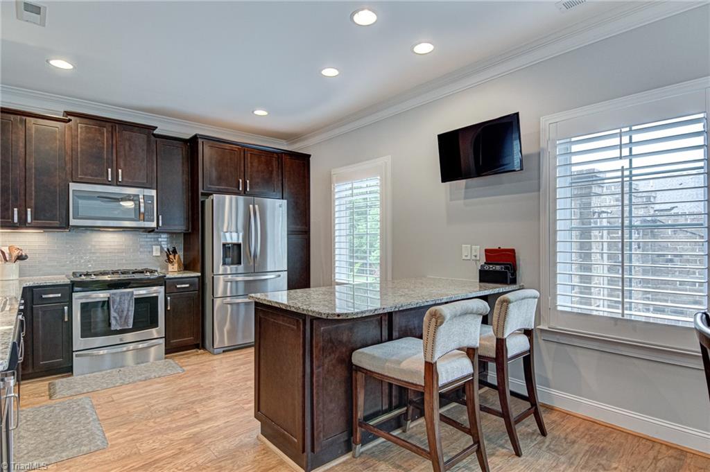 634 Nikyle Circle High Point, NC 27265 - Photo 12 of 32 The kitchen with island eating area will be a place you will hang out a lot. Drinking your morning coffee surfing the net to see what's the latest news.