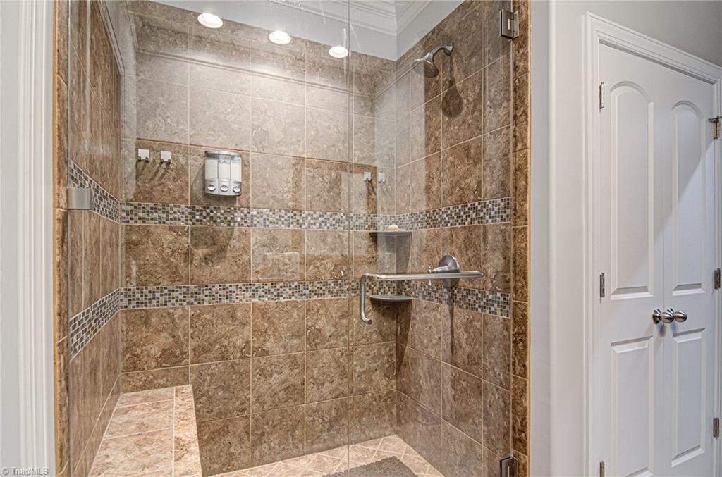 634 Nikyle Circle High Point, NC 27265 - Photo 18 of 32 The tiled Primary shower with seat and frameless door. Another very nice upgrade. Large linen closet also located in the Primary bath.