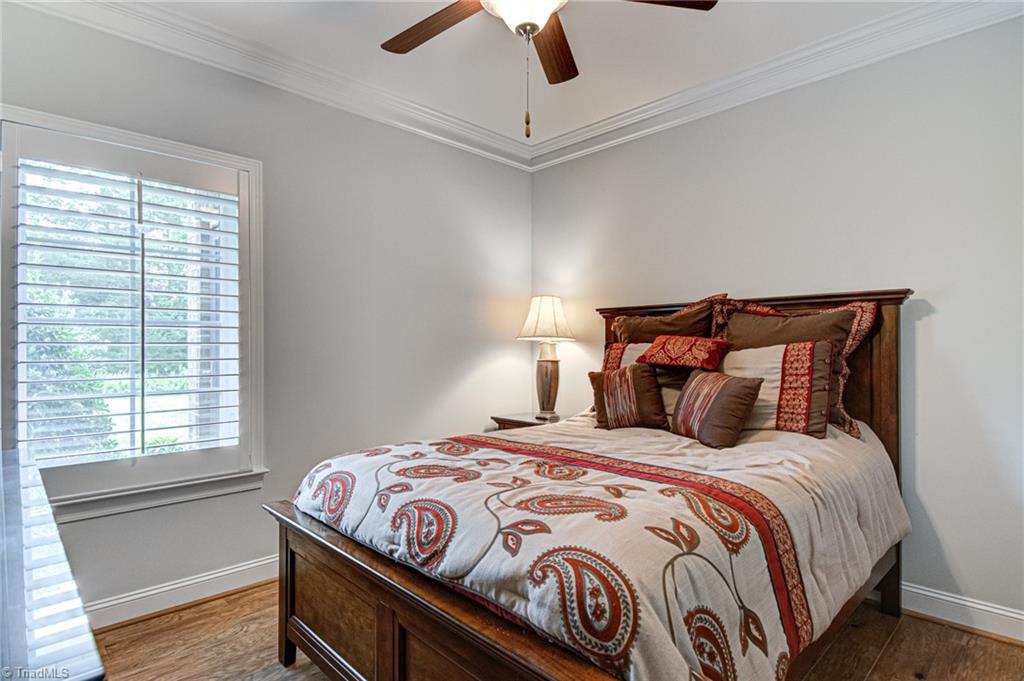 634 Nikyle Circle High Point, NC 27265 - Photo 22 of 32 Bedroom 2 makes the perfect guest suite. Upgraded ceiling fans are in all bedrooms. This room looks out onto the common area with a nice view of yard and trees.