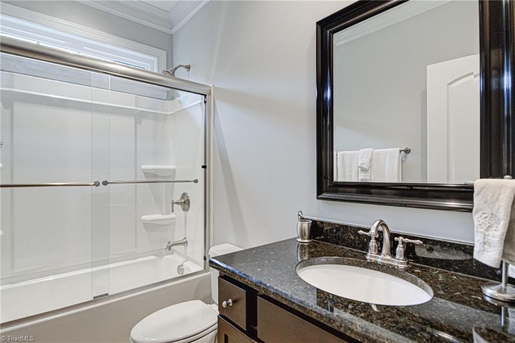 634 Nikyle Circle High Point, NC 27265 - Photo 24 of 32 Bath 2 with granite counter and tiled flooring. The tub and shower combo has upgraded sliiding doors.