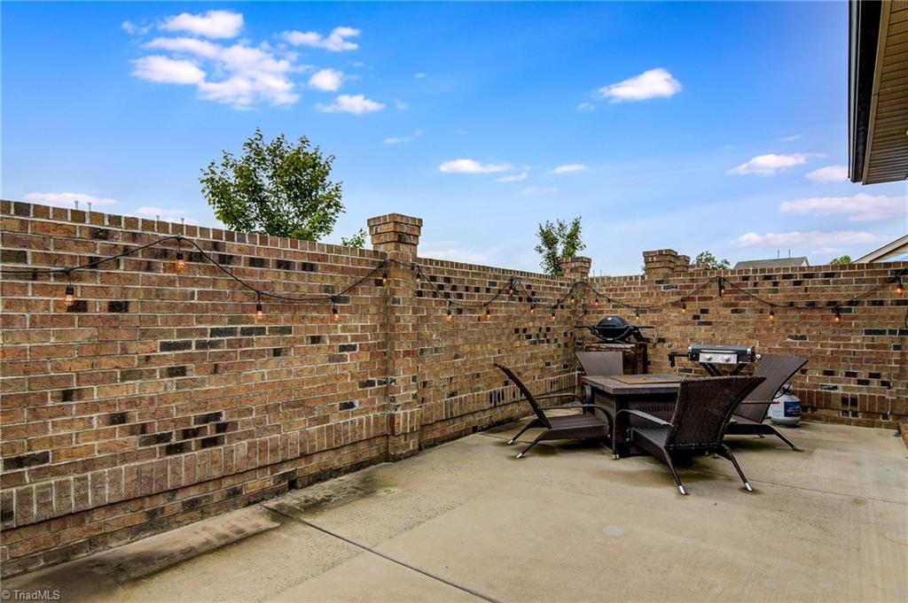 634 Nikyle Circle High Point, NC 27265 - Photo 27 of 32 Another great entertaining space is the brick walled patio. So much space for you to enjoy.