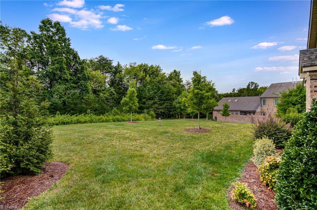 634 Nikyle Circle High Point, NC 27265 - Photo 29 of 32 Being an end unit you get to enjoy this expansive common area surrounded by trees giving you privacy and the feel of a nice lawn space surrounding your home.