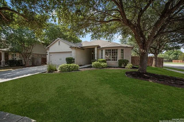 a front view of house with yard and green space