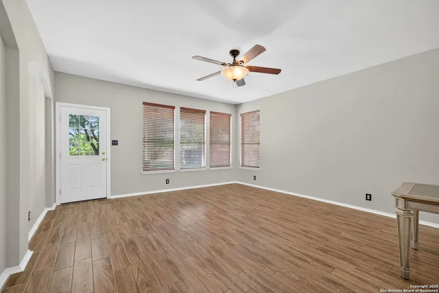 wooden floor in an empty room with a window