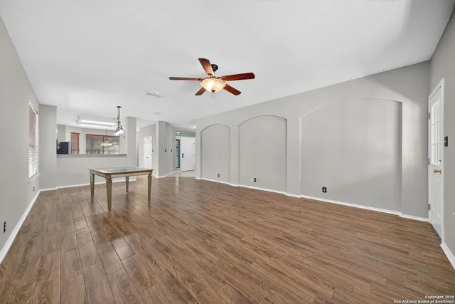a view of workspace with wooden floor and kitchen view