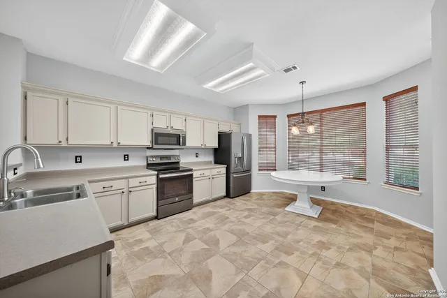 a kitchen with a stove sink and refrigerator