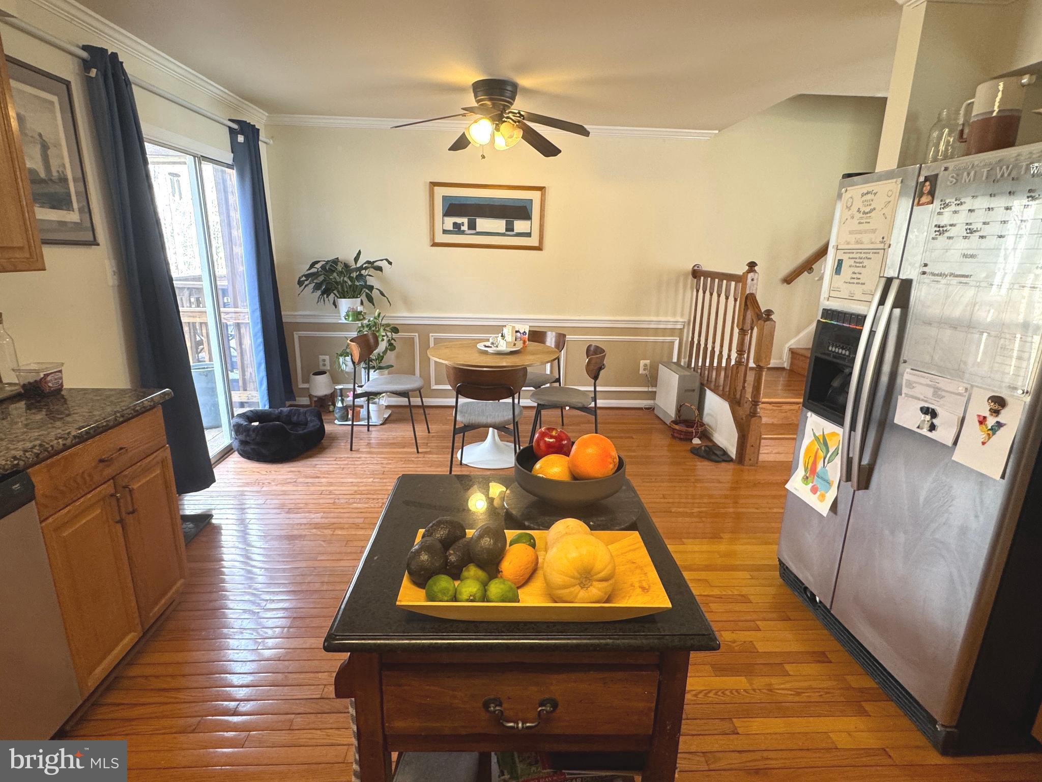 8732 Stone Hill Place Springfield, VA 22153 - Photo 12 of 28 a living room with couches chairs and kitchen view with wooden floor