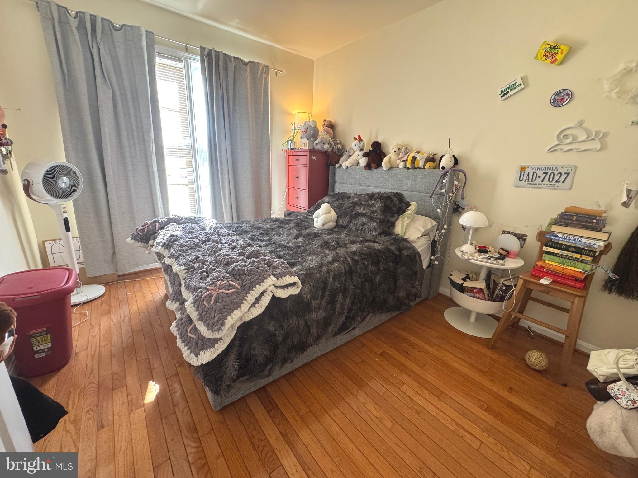 8732 Stone Hill Place Springfield, VA 22153 - Photo 20 of 28 a bedroom with a bed and wooden floor
