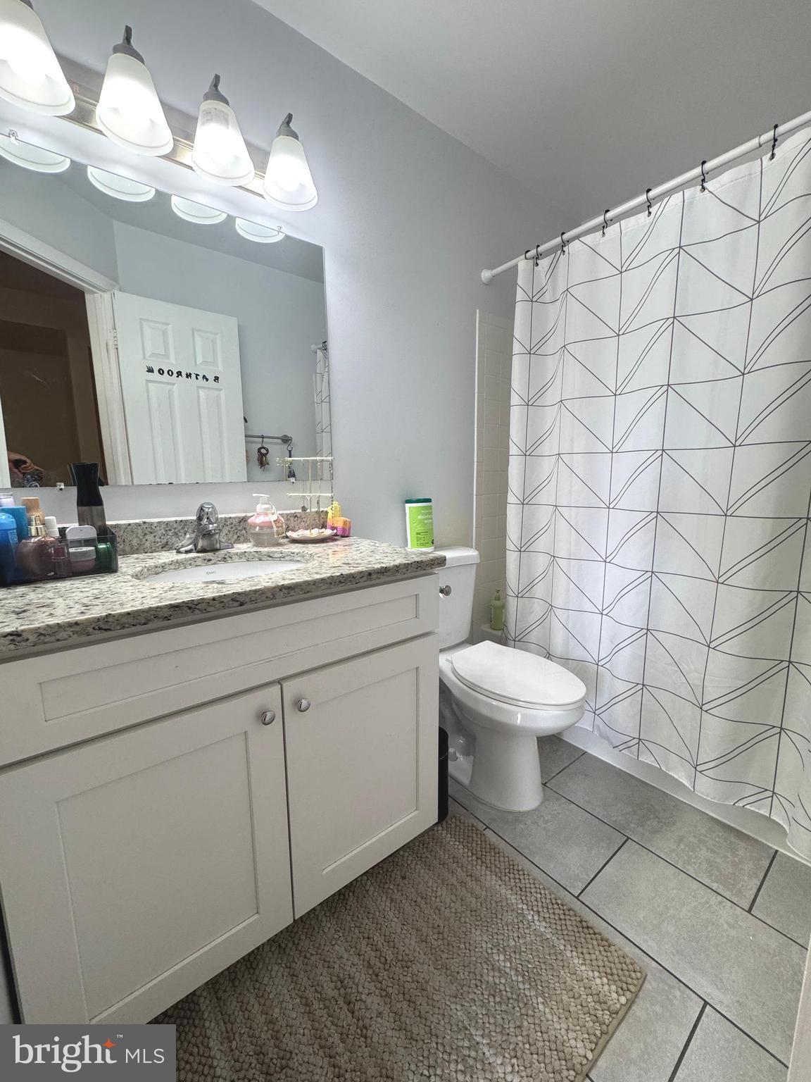 8732 Stone Hill Place Springfield, VA 22153 - Photo 21 of 28 a bathroom with a toilet sink and mirror
