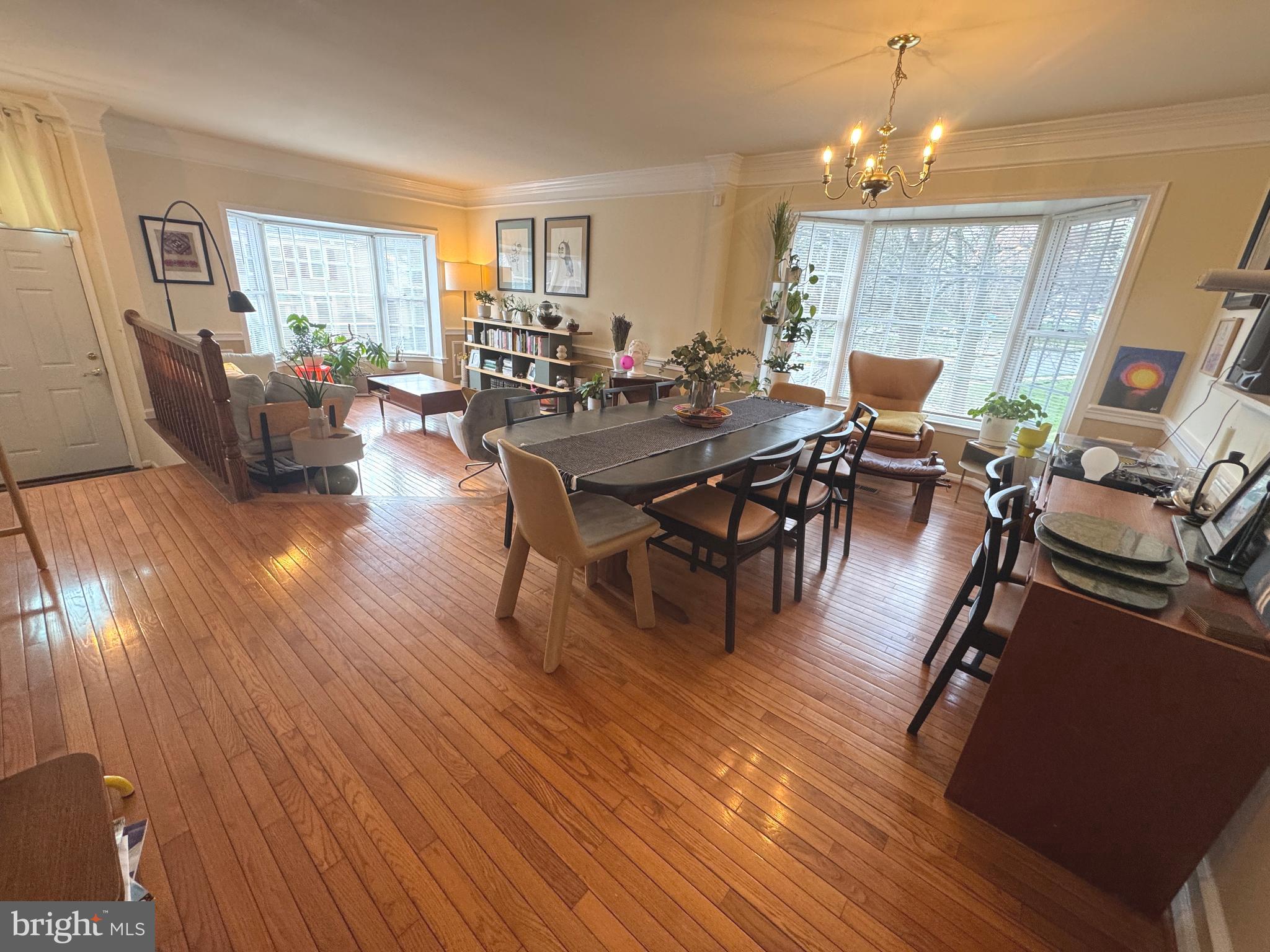 8732 Stone Hill Place Springfield, VA 22153 - Photo 3 of 28 a living room with furniture a dining table wooden floor and a window
