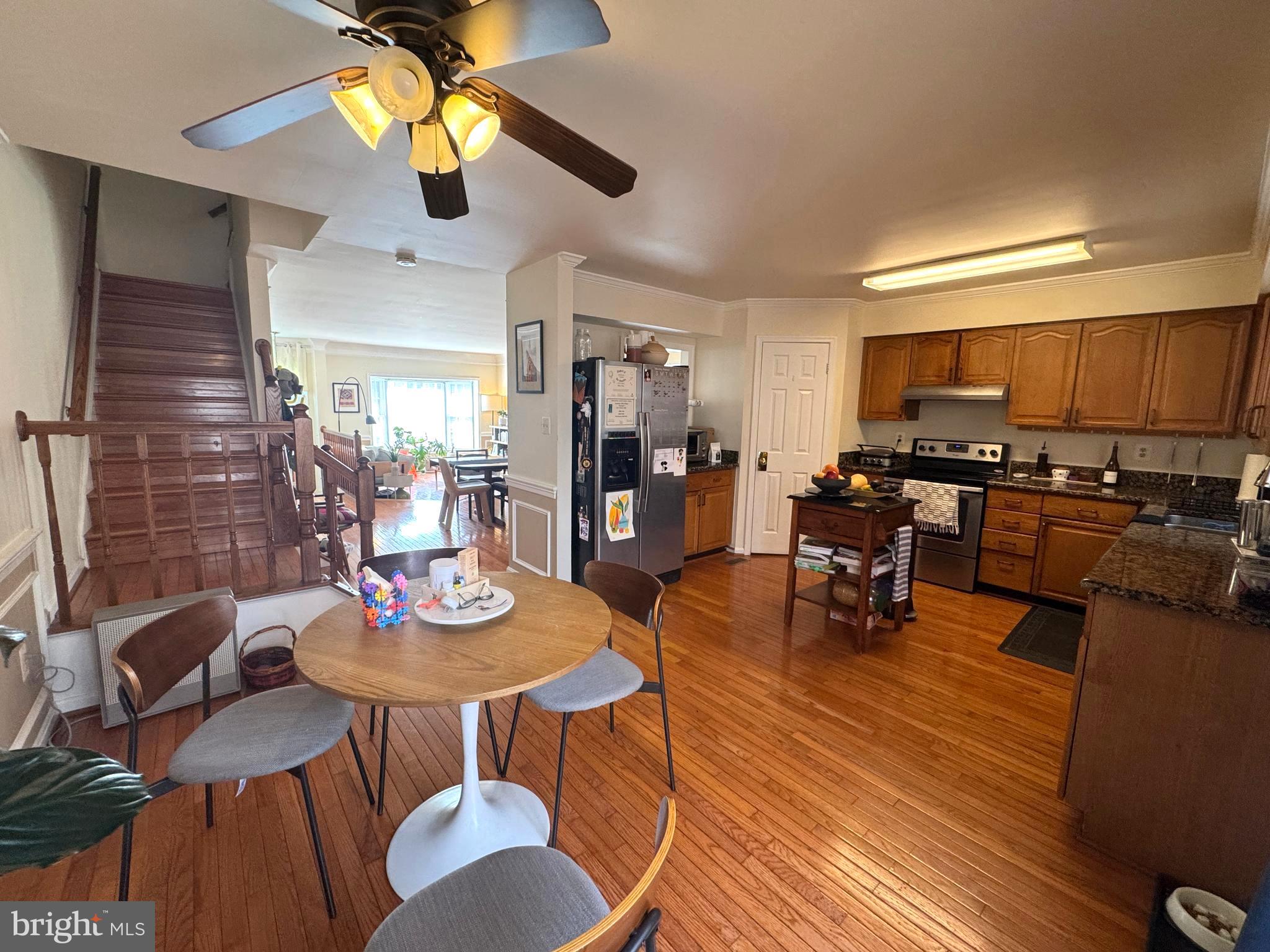 8732 Stone Hill Place Springfield, VA 22153 - Photo 10 of 28 a kitchen with stainless steel appliances kitchen island granite countertop a table chairs and a stove
