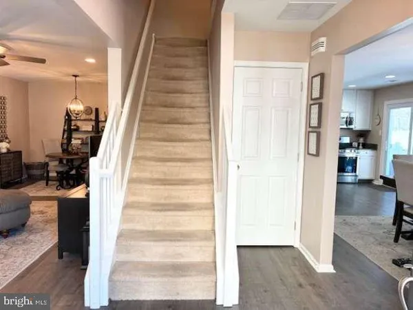 a view of a hallway with wooden floor and entryway