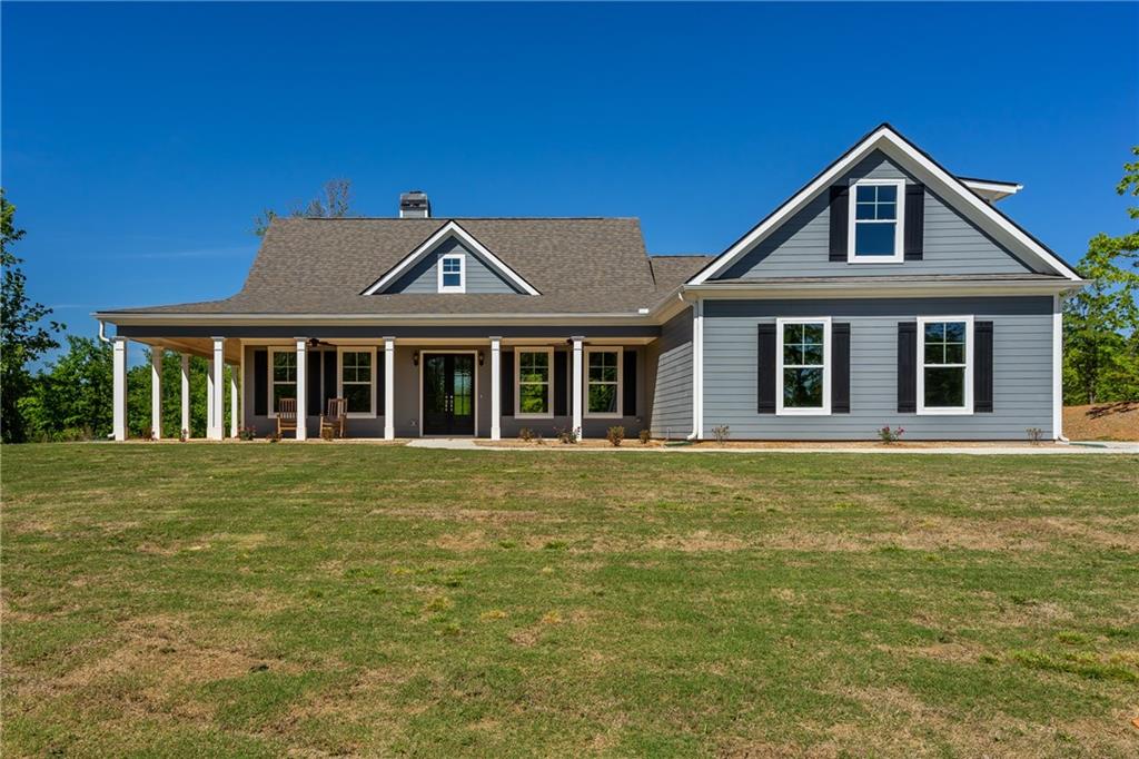 2328 Carlan Road Fairmount, GA 30139 - Photo 1 of 1 a front view of a house with a garden