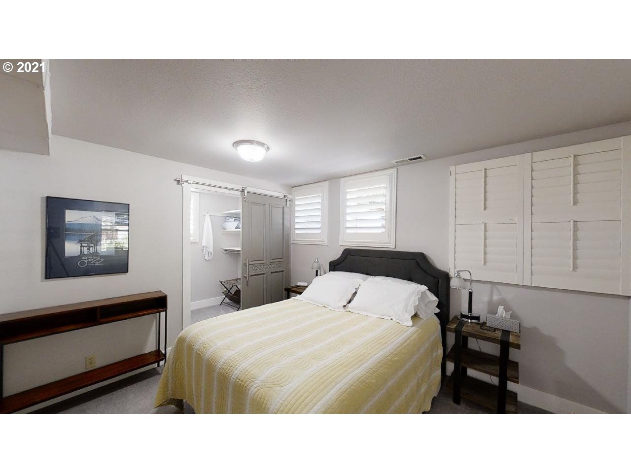 555 River Loop 1 Eugene, OR 97404 - Photo 19 of 28 a room with a bed and a painting on the wall