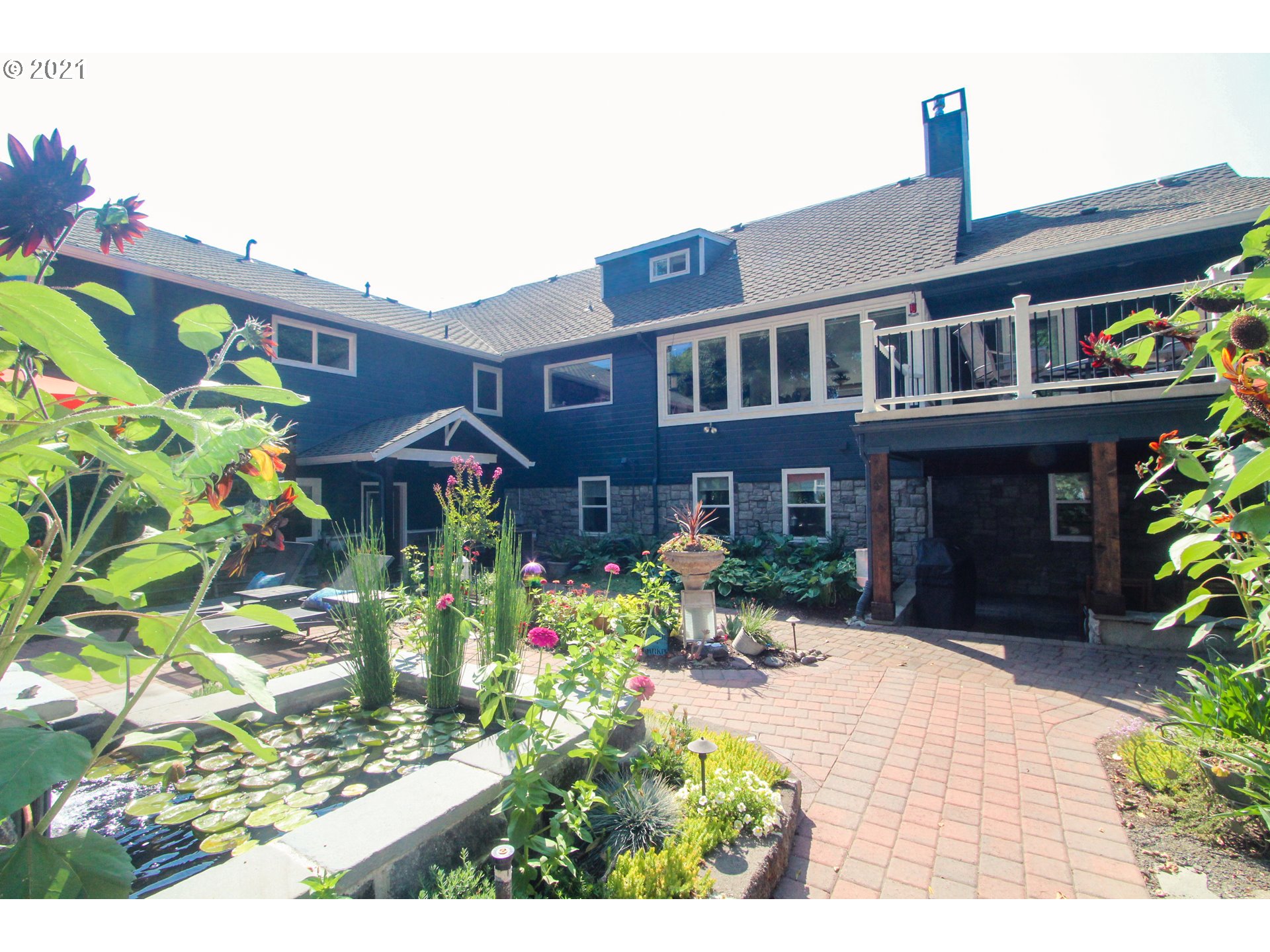 555 River Loop 1 Eugene, OR 97404 - Photo 22 of 28 a front view of a house with a yard and potted plants