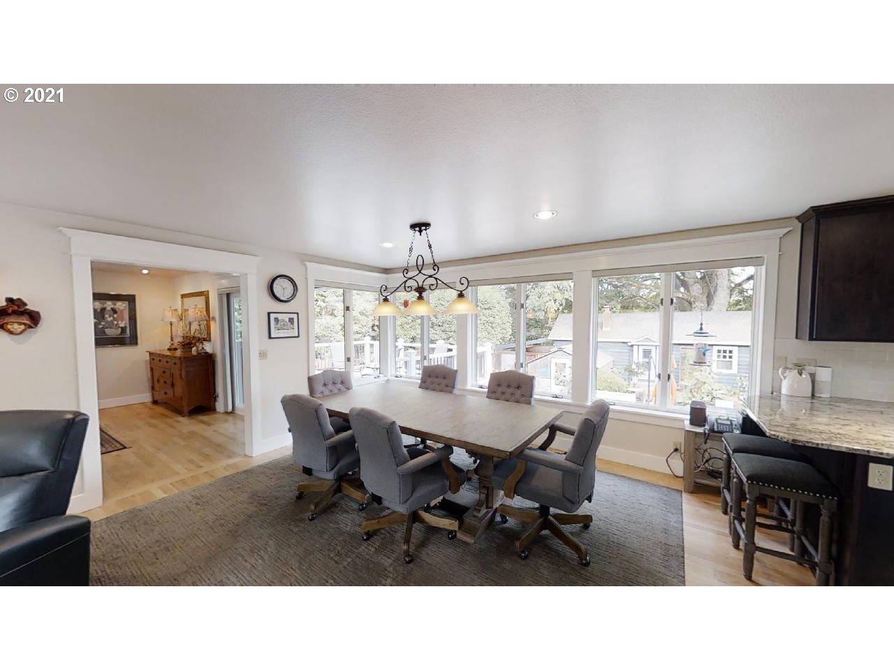 555 River Loop 1 Eugene, OR 97404 - Photo 5 of 28 a living room with dining table and a flat screen tv