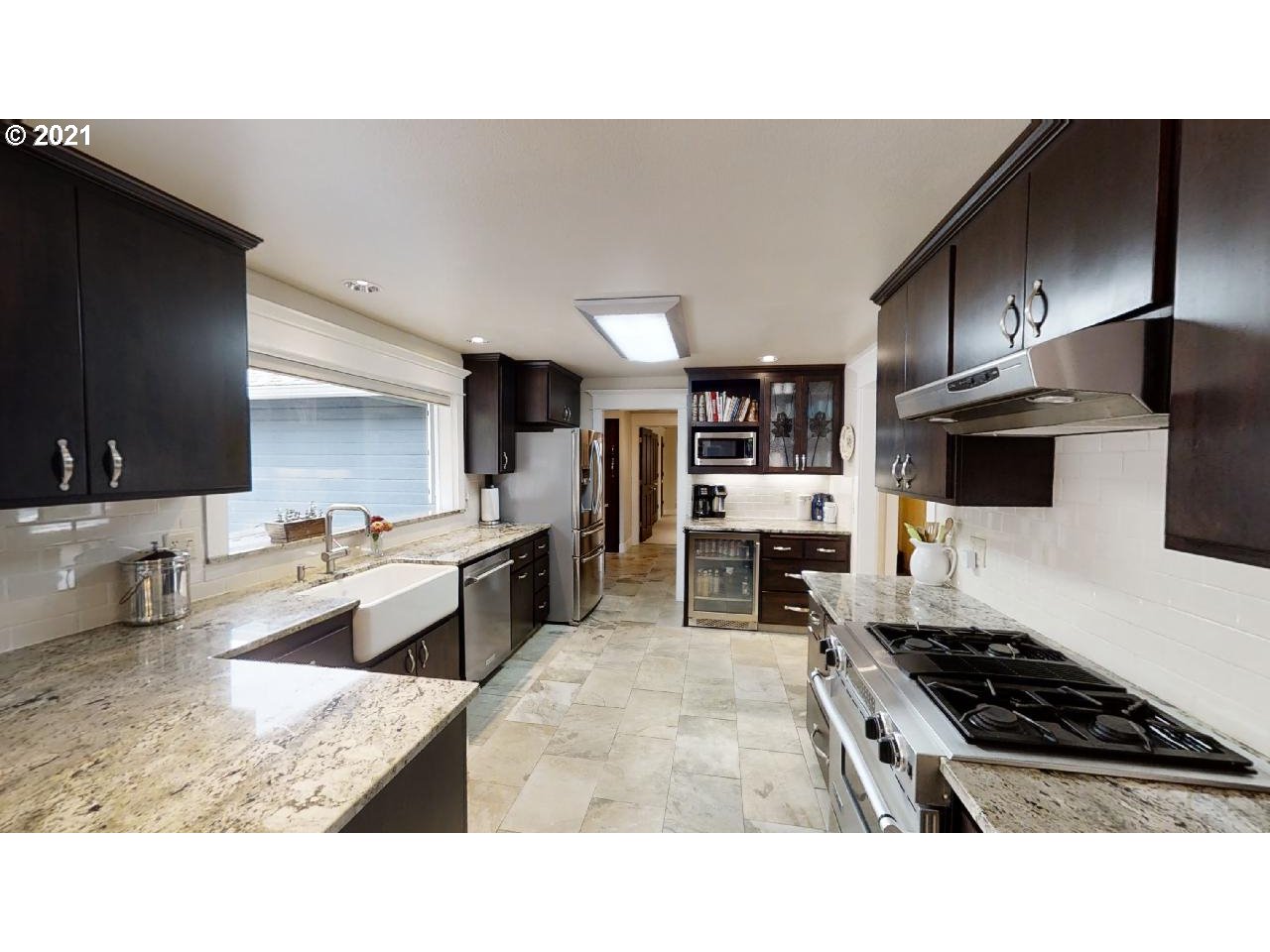 555 River Loop 1 Eugene, OR 97404 - Photo 8 of 28 a kitchen with stainless steel appliances kitchen island granite countertop a sink counter space and cabinets